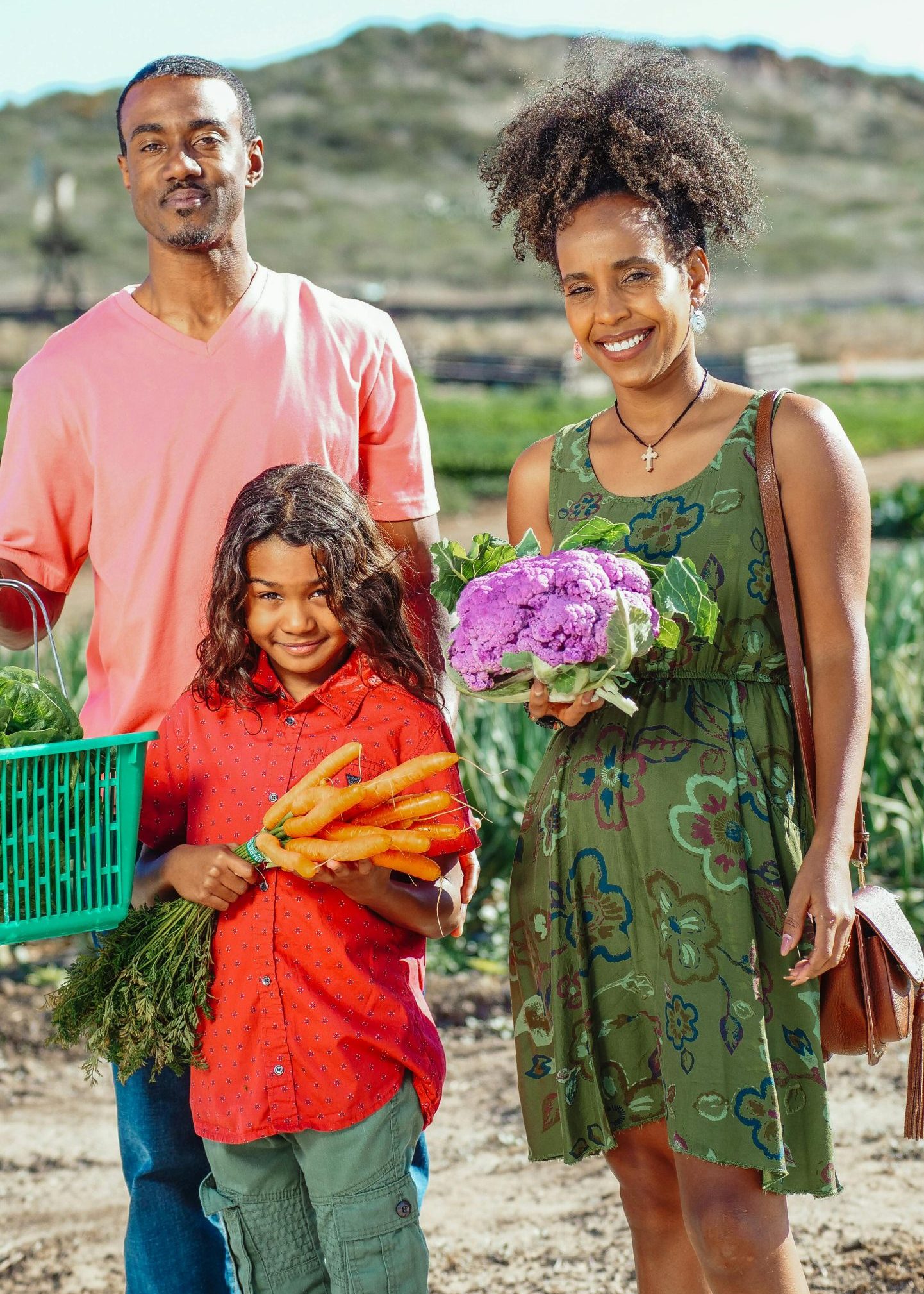 A joyful family enjoying fresh produce at a sunny farmers market.